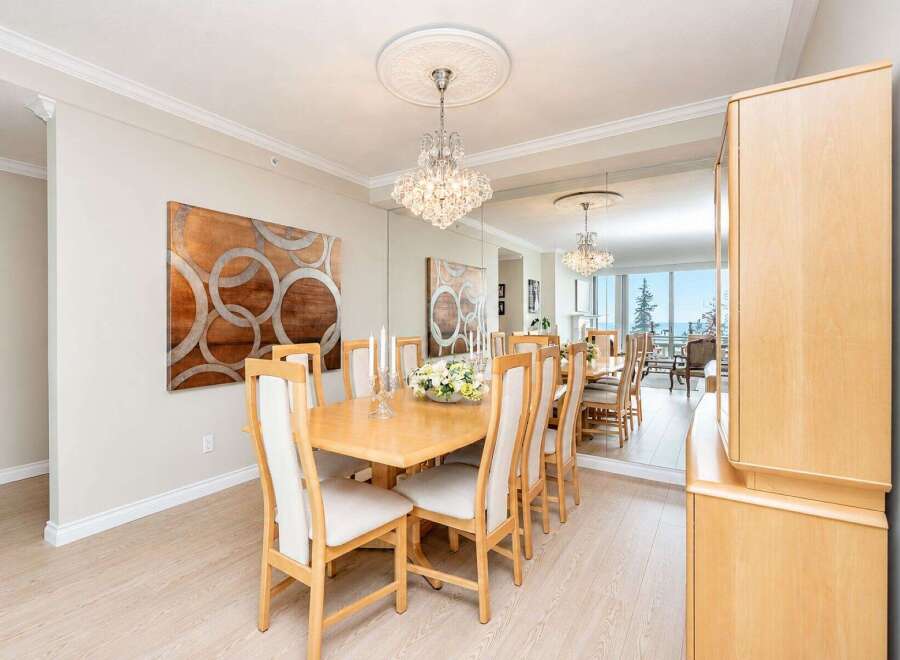 Experience elegant dining in this beautifully appointed space, featuring a large wooden table surrounded by upholstered chairs.