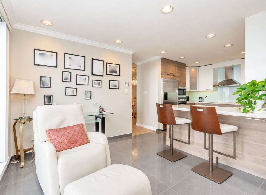 This modern condo features an open-concept living and kitchen area, perfect for entertaining.