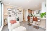 This modern condo features an open-concept living and kitchen area, perfect for entertaining.