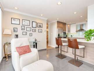 This modern condo features an open-concept living and kitchen area, perfect for entertaining.