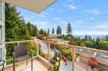 Enjoy breathtaking panoramic views of the water and lush greenery from this stunning balcony.