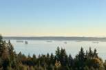 Experience breathtaking panoramic views of the water and distant mountains from this stunning property.
