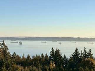 Experience breathtaking panoramic views of the water and distant mountains from this stunning property.