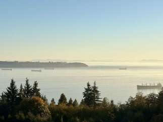 Experience breathtaking panoramic views of the ocean and distant mountains from this stunning property.