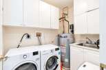 This laundry room boasts a full-sized washer and dryer, ensuring ample space for all your laundry needs.