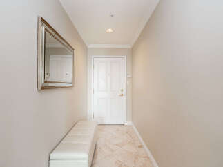 Step into this welcoming entryway, featuring a stylish tufted bench perfect for removing shoes.