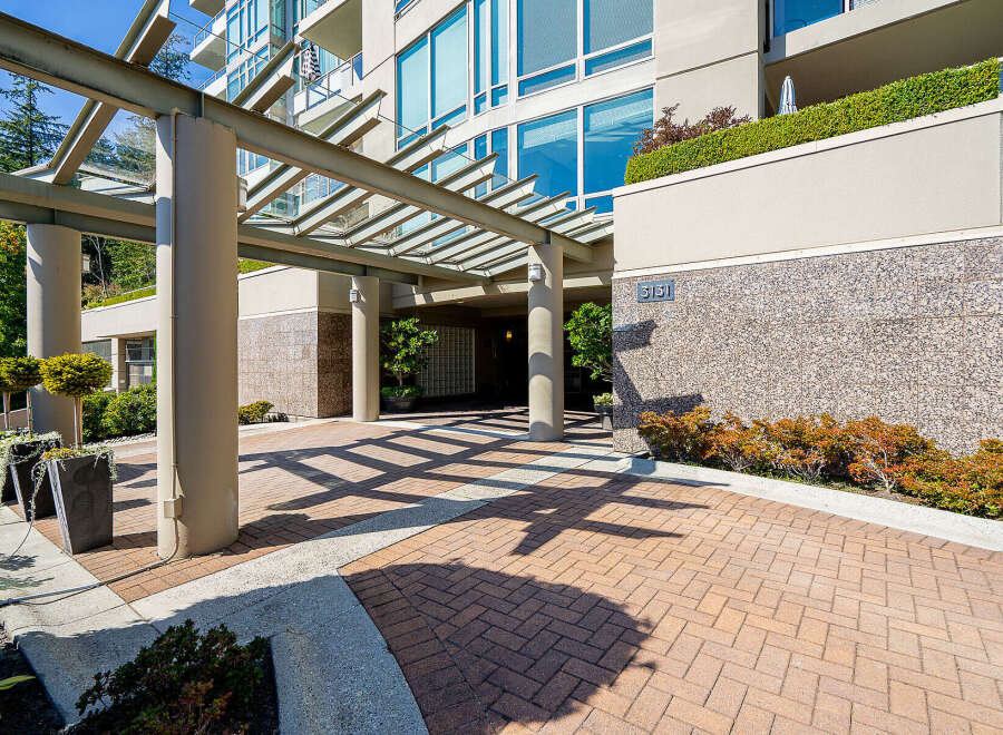 Welcome to this stunning property featuring a modern entrance with a covered walkway and elegant landscaping.