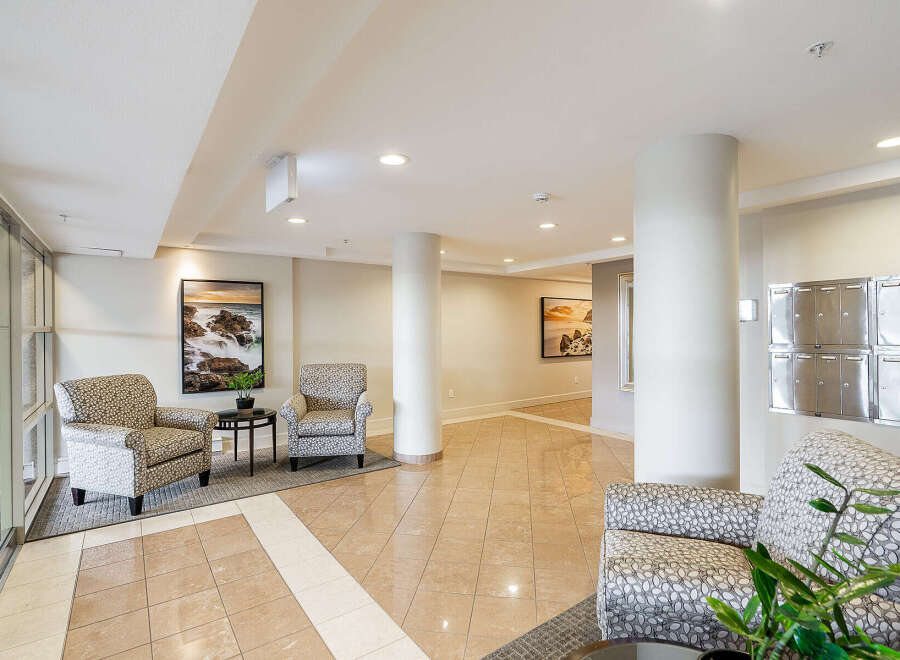 Step into this elegant lobby featuring comfortable seating areas perfect for residents and guests.
