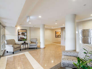 Step into this elegant lobby featuring comfortable seating areas perfect for residents and guests.