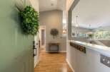 Step into a welcoming entryway featuring a light green door adorned with a lush green wreath.
