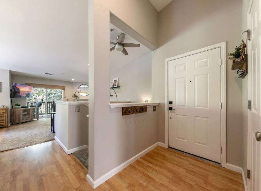 Step into a welcoming entryway featuring a white paneled door and a convenient coat rack.