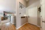 Step into a welcoming entryway featuring a white paneled door and a convenient coat rack.