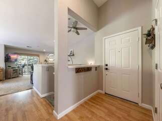 Step into a welcoming entryway featuring a white paneled door and a convenient coat rack.