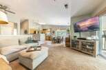 Experience open-concept living in this beautifully appointed home, featuring a spacious living area seamlessly flowing into a modern kitchen and dining space.