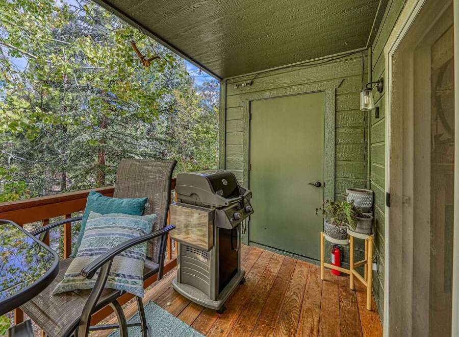 Enjoy outdoor living on this charming deck, complete with a grill for summer barbecues and comfortable seating for relaxation.