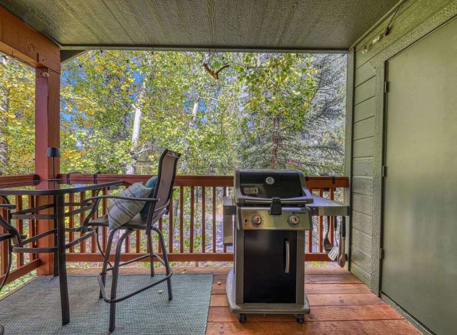 Enjoy outdoor living on this charming covered deck, perfect for entertaining or relaxing amidst nature.