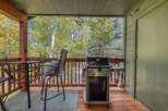 Enjoy outdoor living on this charming covered deck, perfect for entertaining or relaxing amidst nature.