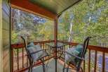 Enjoy your morning coffee or evening drinks on this charming balcony, complete with a glass-top table and two comfortable chairs adorned with decorative pillows.