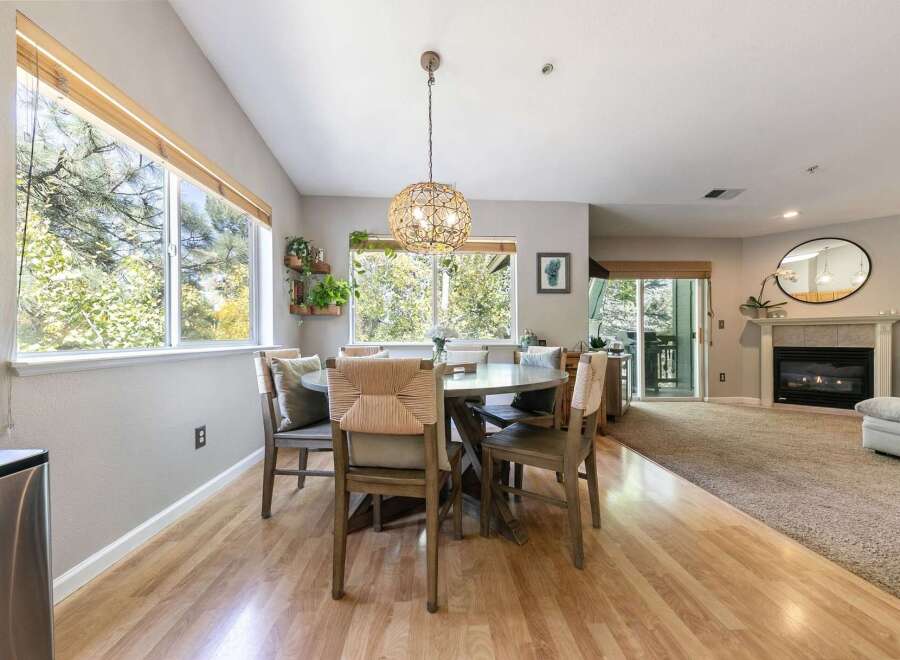 Enjoy natural light and scenic views from the large windows in this inviting dining area, perfect for family meals.