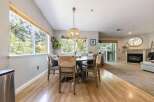 Enjoy natural light and scenic views from the large windows in this inviting dining area, perfect for family meals.