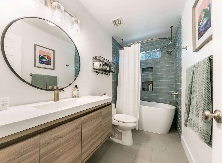 This modern bathroom features a sleek vanity with ample storage and a minimalist aesthetic.