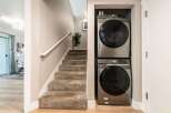 This home features a convenient stacked washer and dryer unit, perfect for maximizing space in a laundry area or hallway.