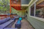 Enjoy outdoor living on this spacious patio, complete with a comfortable sectional sofa and a modern fire pit.