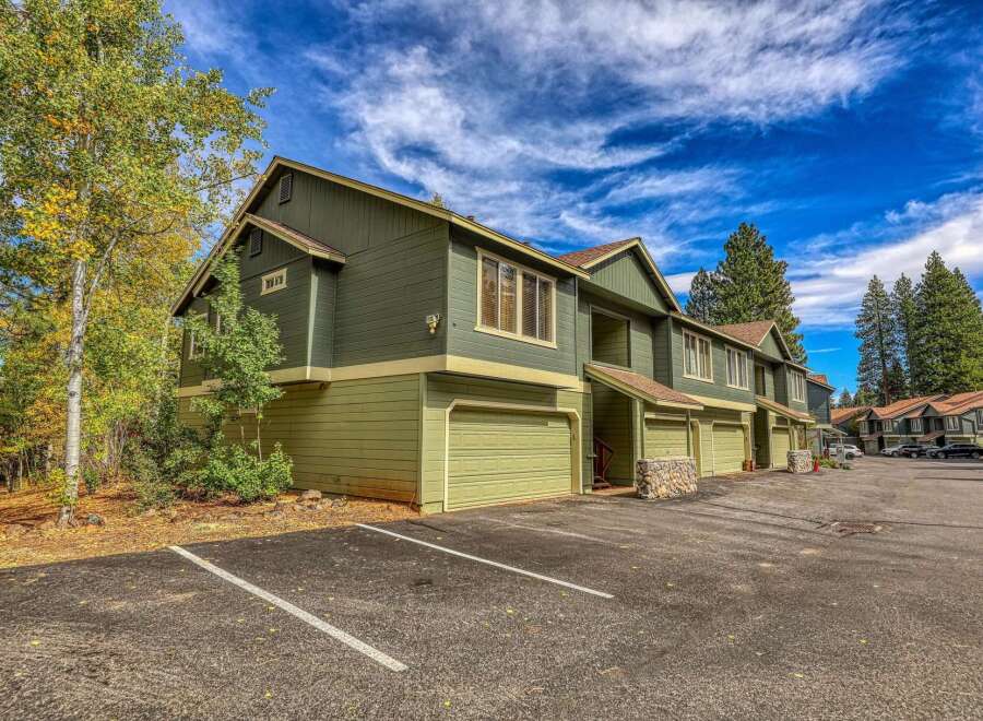 Discover this charming multi-unit property featuring a classic green exterior and attached garages, perfect for a rental investment or multi-family living.