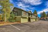 Discover this charming multi-unit property featuring a classic green exterior and attached garages, perfect for a rental investment or multi-family living.