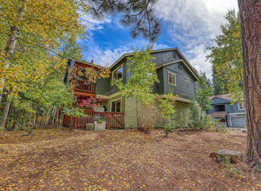 Nestled amidst vibrant autumn foliage, this charming home offers a serene retreat.