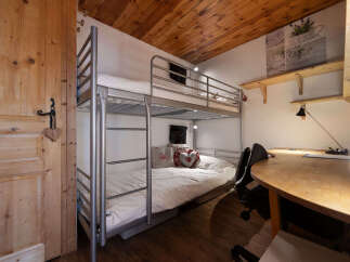 This cozy room features a space-saving bunk bed, perfect for maximizing sleeping arrangements.
