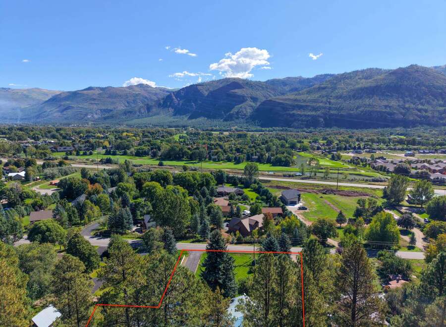 Discover this stunning property nestled amidst mature trees, offering breathtaking views of the surrounding mountains.