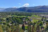 Discover this stunning property nestled amidst mature trees, offering breathtaking views of the surrounding mountains.