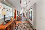 Step into this charming hallway, featuring a warm wooden floor and elegant Persian rugs that guide you through the space.