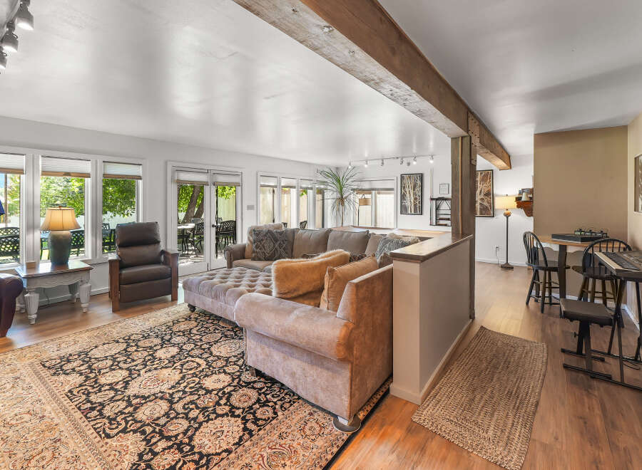 Step into this inviting living space featuring a large sectional sofa and plush ottomans, perfect for relaxation and entertaining.