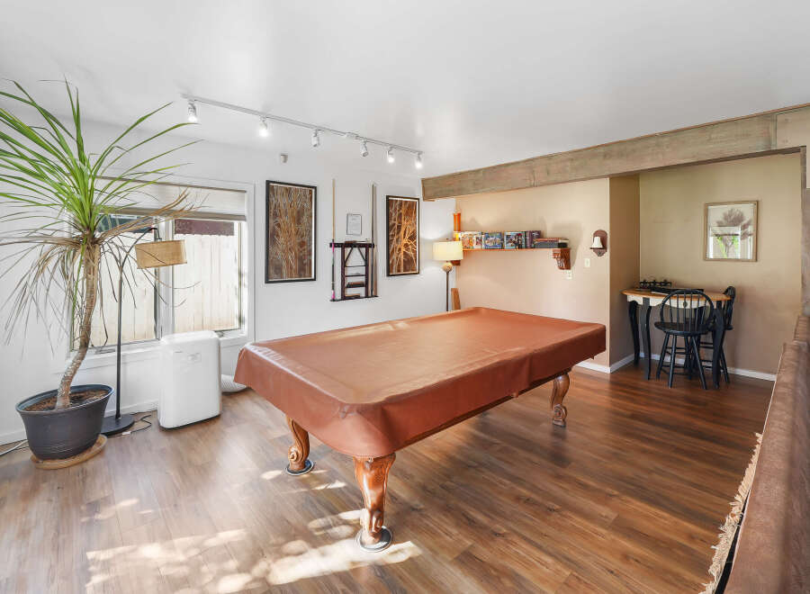 Step into this versatile game room, perfect for entertaining guests or enjoying a night in.