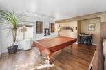 Step into this versatile game room, perfect for entertaining guests or enjoying a night in.