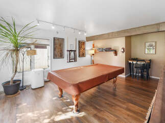 Step into this versatile game room, perfect for entertaining guests or enjoying a night in.