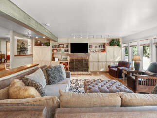 Step into this inviting living room, featuring a large sectional sofa and a plush ottoman perfect for relaxation.