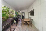 Enjoy outdoor living on this spacious covered deck, perfect for entertaining.