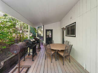 Enjoy outdoor living on this spacious covered deck, perfect for entertaining.