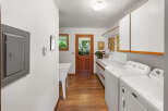 This spacious laundry room features a large utility sink and ample counter space, perfect for folding clothes.
