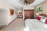Experience rustic charm in this inviting bedroom, featuring a stunning wooden ceiling fan and elegant barn doors.