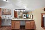 This spacious bathroom features a double vanity with granite countertops and ample storage.