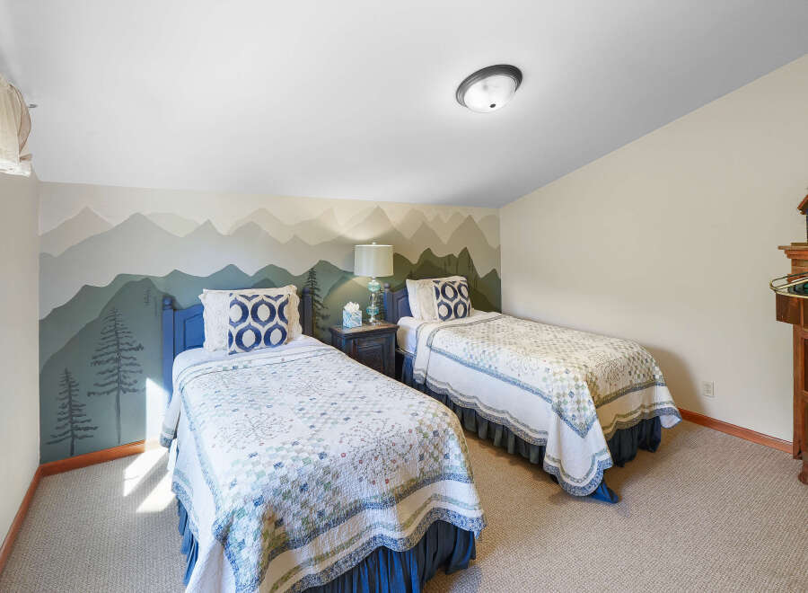 This charming bedroom features two twin beds, perfect for accommodating guests or family.