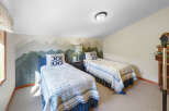 This charming bedroom features two twin beds, perfect for accommodating guests or family.