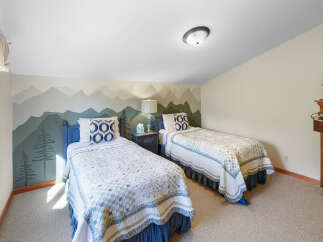 This charming bedroom features two twin beds, perfect for accommodating guests or family.
