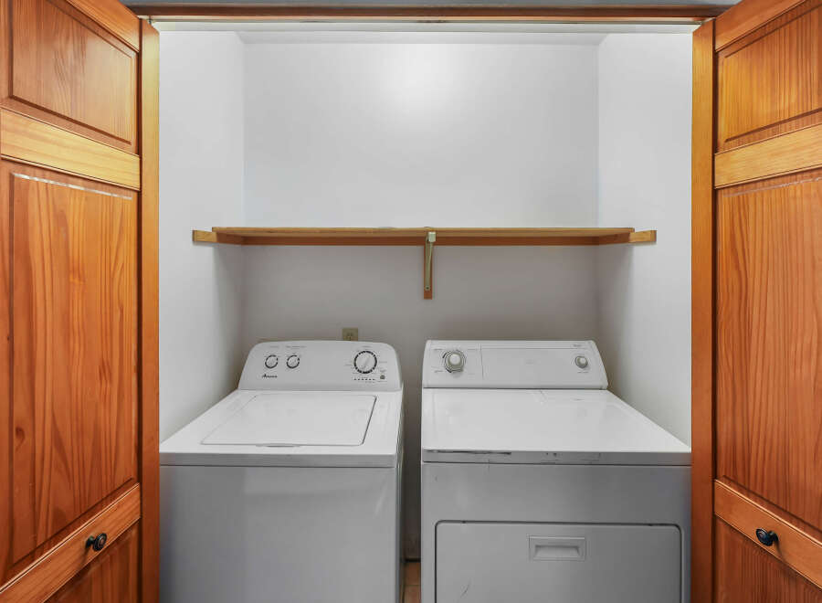 Discover the convenience of a dedicated laundry space featuring a top-load washer and a front-load dryer, perfect for handling all your laundry needs.