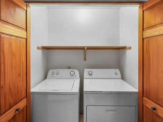 Discover the convenience of a dedicated laundry space featuring a top-load washer and a front-load dryer, perfect for handling all your laundry needs.