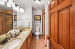 This beautifully appointed bathroom features a double vanity with granite countertops and elegant oil-rubbed bronze fixtures.